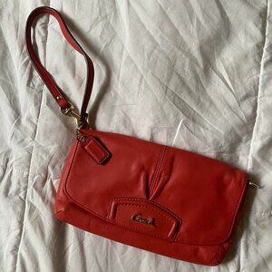 coach ashley leather flap wristlet in a coral pink